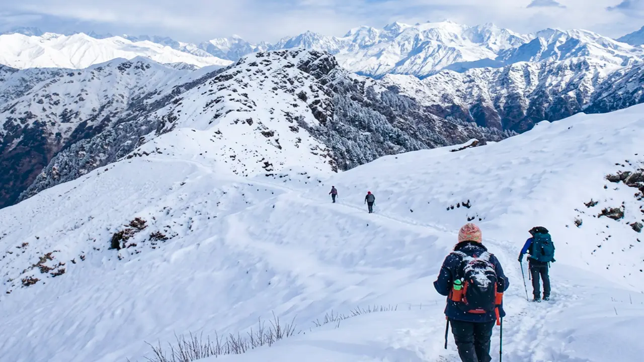Trekkers crossing a snowy landscape during the Panwali Kantha Trek